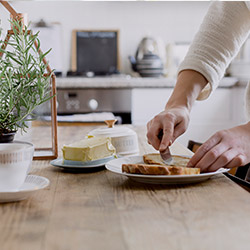 Buttering toast in a kitchen